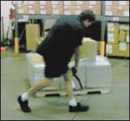 Figure 40. Manually wrapping a pallet can require torso bending.