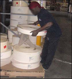 Figure 32. Heavy lifting of rolls from supply pallets.