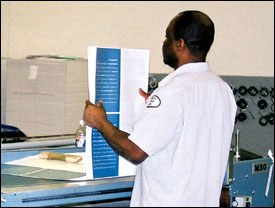 Figure 32. Fanning paper for folding. Notice the thin stack being fanned.