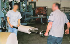 Figure 12. Using the buddy system for handling roll shafts with rolls attached.