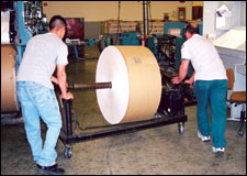 Figure 13. Using a roll cart with power lift to move rolls to press units.