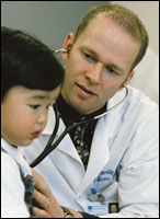 Physician with stethoscope and young boy