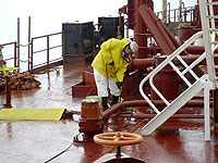 Figure 2: Worker removing liquid residues from space using bucket