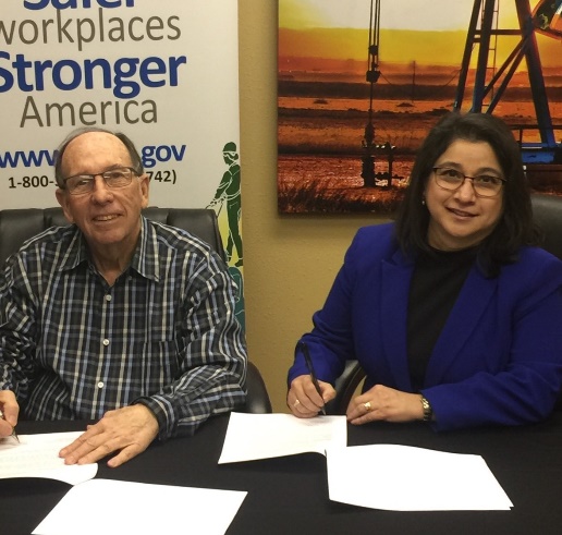 Phil Young of West Texas Safety Training Center and Lubbock Area Director Elizabeth Routh sign alliance to protect oil and gas employees.