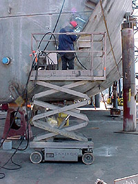 Image of worker using scissor lift