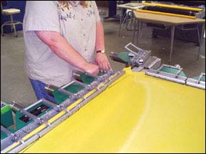 Figure 5. Table level at proper  height for this employee to exert force on clamps without stressful bending.