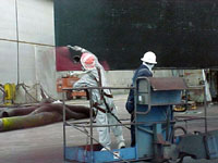 Figure 12: Worker protected by filter respirator during spray painting hull