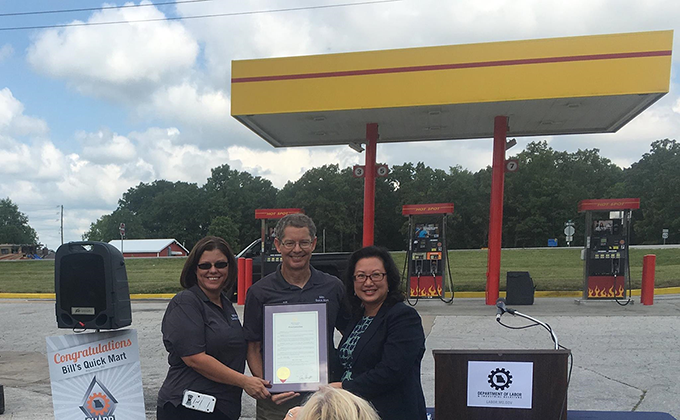 Holding Missouri Governor Eric R. Greiten's proclamation to Bill's Quick Mart: From left to right: Linda Collins – Vice President; Bill Spurlock – Owner; and Anna Hui – Director, Missouri Department of Labor