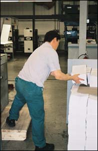 Figure 28. This employee is working at an awkward angle and at different heights that cause him to bend and twist uncomfortably even when loading at upper levels of pallet.