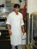 Image of a young worker wearing a proper length apron