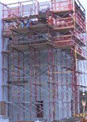 AMWTF Project, May 1, 2002: Elevator/stairwell shaft Construction employees use scaffolding surrounding the elevator/stairwell shaft for CMU placing.