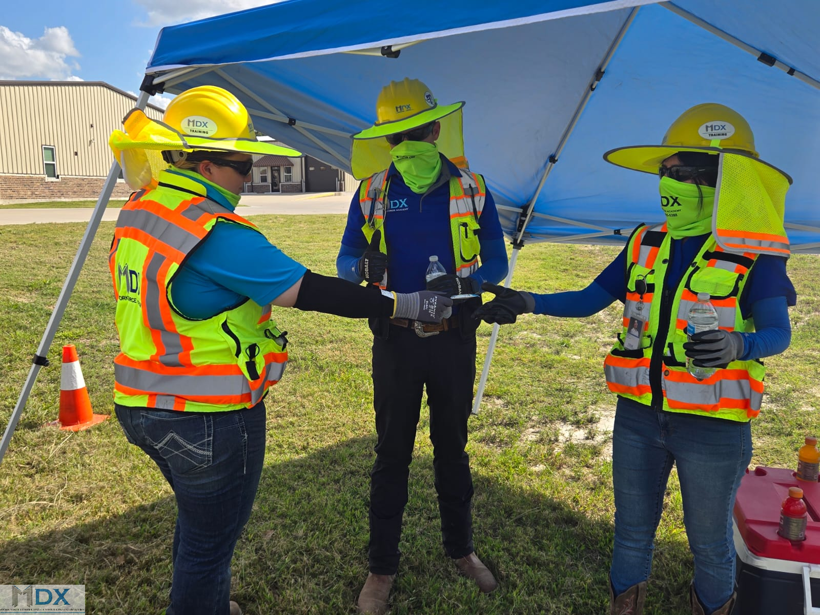 MDX Workforce Consulting Center & Training Academy : workers taking a break and consuming water and electrolyte-containing beverages