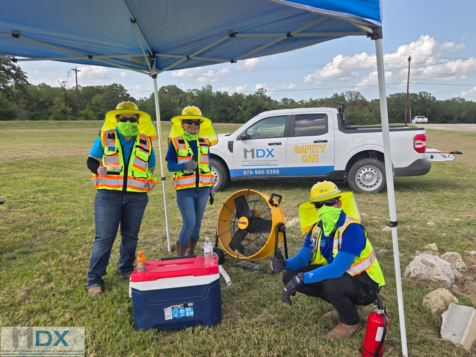 MDX Workforce Consulting Center & Training Academy : crew under canopy with portable fan