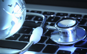 Stethoscope and globe on laptop keyboard - Photo Credit: iStock - 512958437 | copyright - deepblue4you