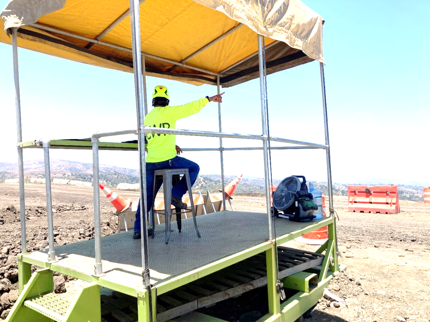 OC Waste & Recycling- Olinda Alpha Landfill : employee directs commercial disposal trucks to their designated areas