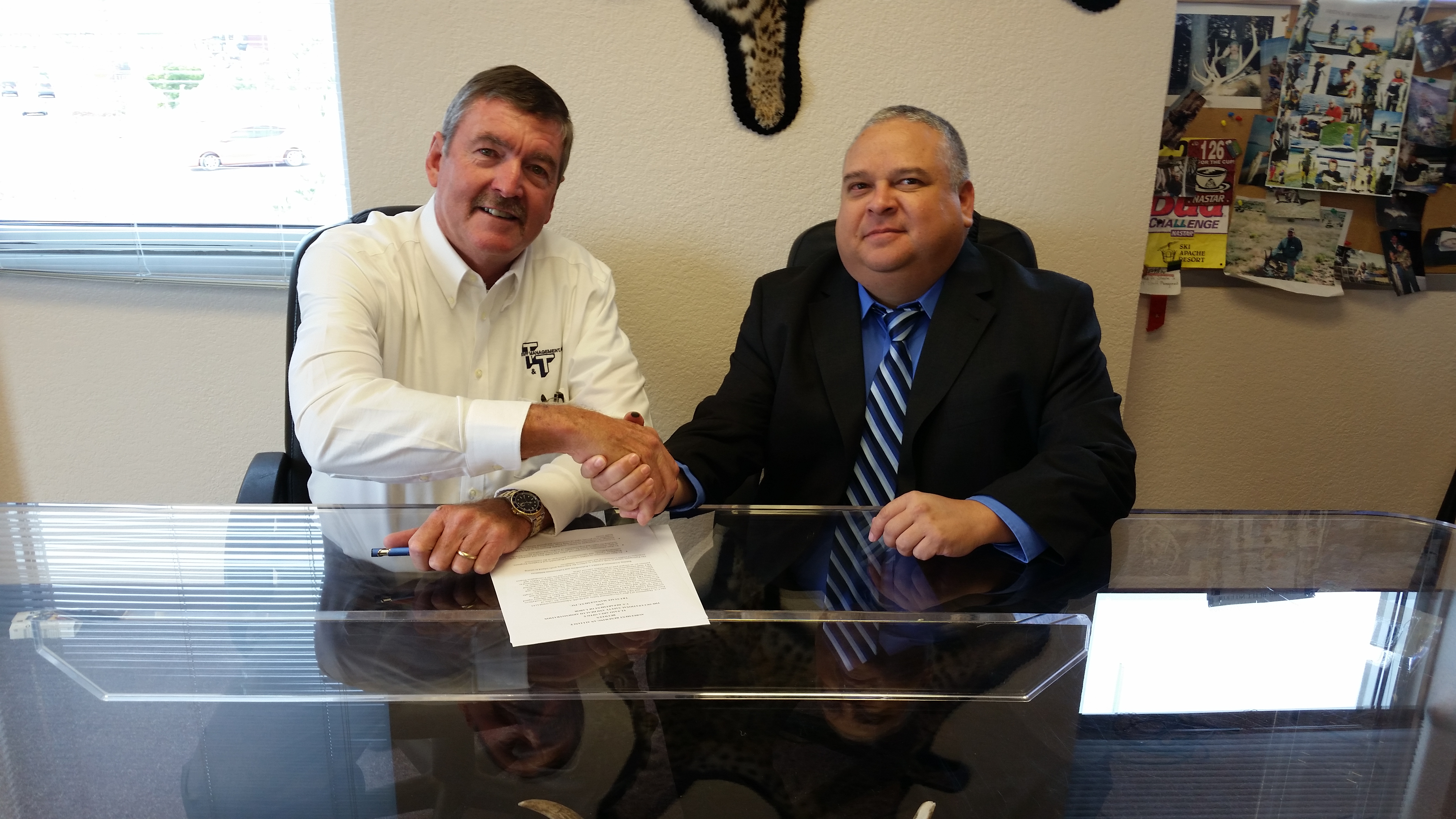 Thad Steele (left), president of T&T Staff Management Inc., and Diego Alvarado Jr. (right), area director in El Paso for the U.S. Department of Labor's Occupational Safety and Health Administration, signing the alliance agreement today at the T&T Staff Management's office in El Paso.