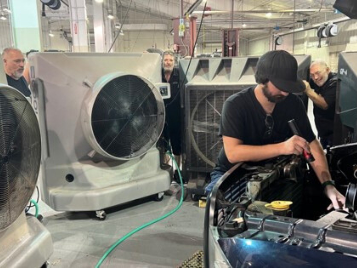 Professional Contract Services, Inc. : workers are adding cooling towels to ice-cold water and then putting the towels around their necks to help cool their bodies