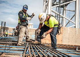 Construction workers building flat rooftop