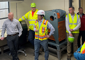 Bartlett Grain workers and Assistant Secretary of Labor Doug Parker wearing safety gear during a meeting