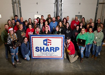 Haltec Corporation Salem, Ohio facility employees posing with their SHARP flag