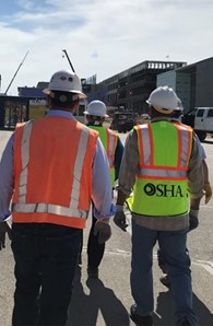 Workers wearing PPE while walking through construction site