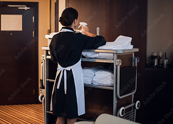 Housekeeping worker setting up her cart