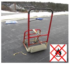 Figure 1: The dolly-type roller device used in a way that does not meet OSHA's requirements for spreading flammable adhesives.