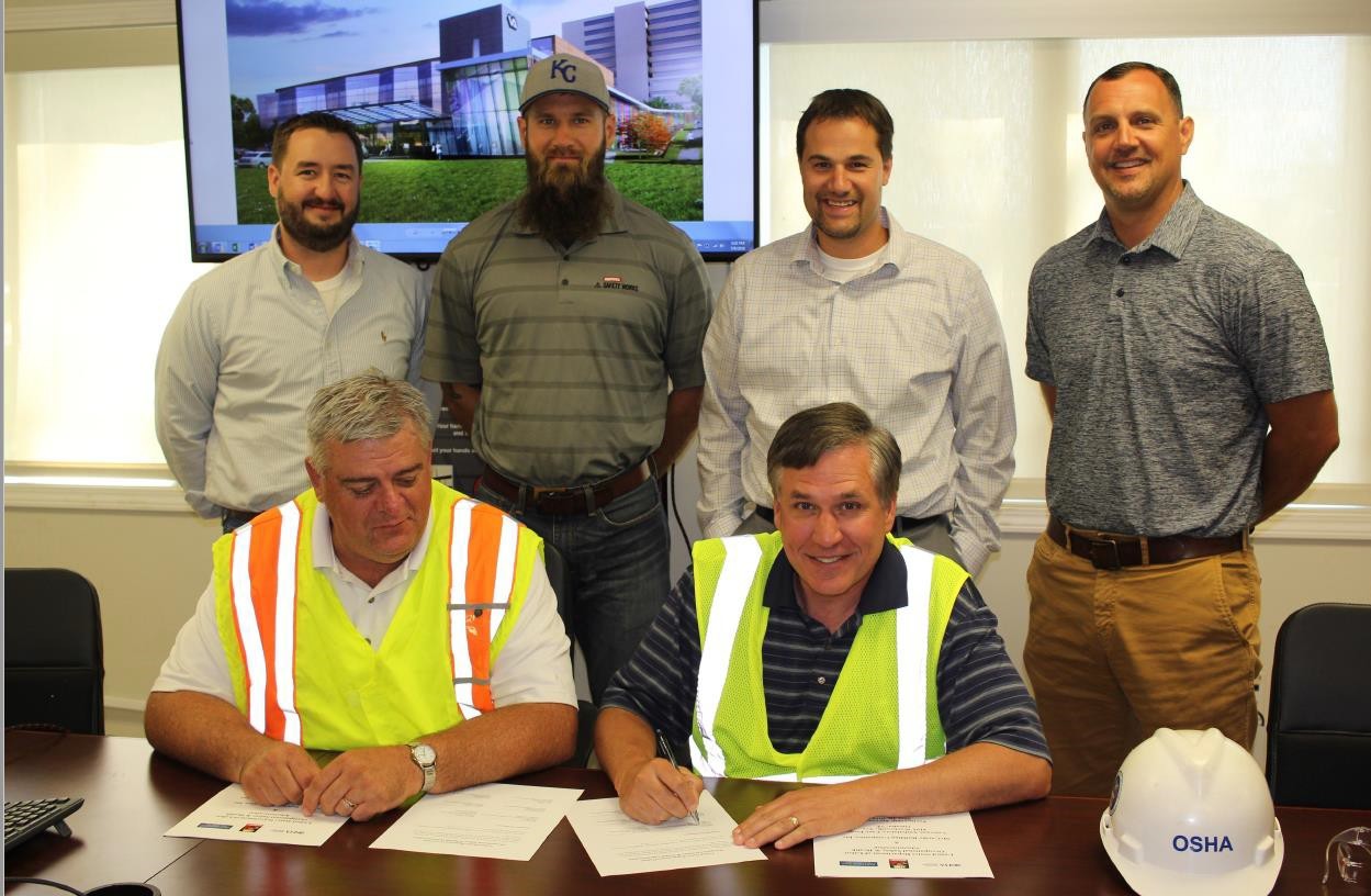 Signing of OSHA Partnership in 2018 (Front) Darwin Craig, Assistant Area Director; Jeff Funke, Area Director (Back) Kris Montgomery, Project Manager; Andy Parrish, Safety Manager; Ryan Sawall, Vice President