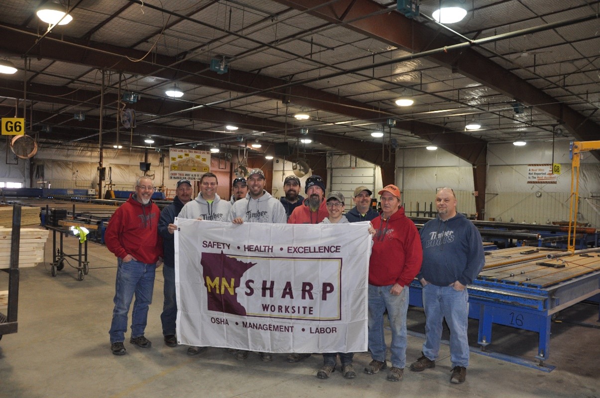 Timber Roots Safety Committee receiving their SHARP flag